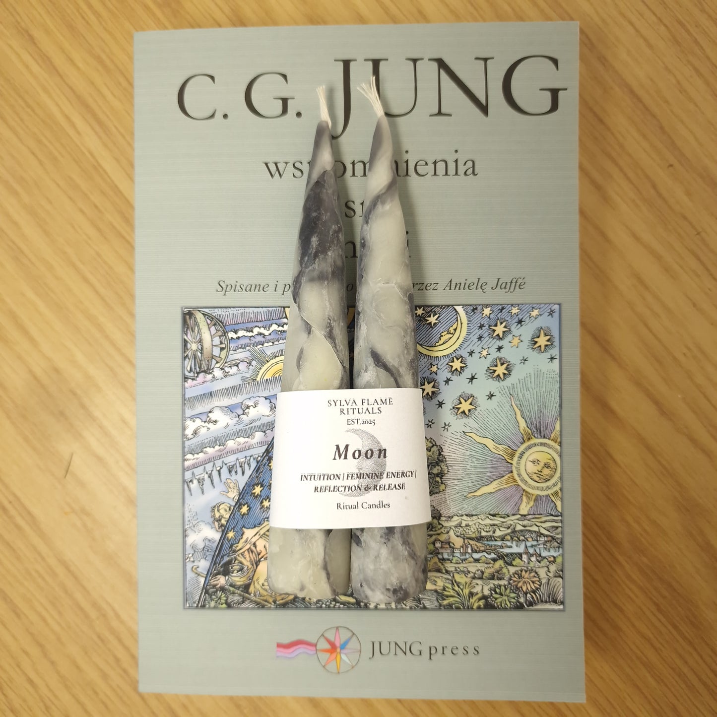 Handmade, beeswax candles with white and black marble effect on the book.